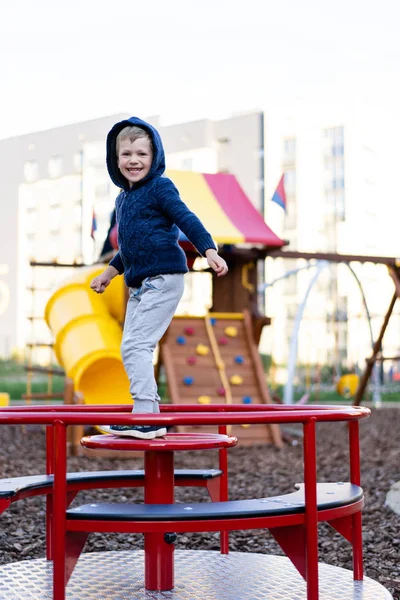 A little boy is having fun playing on the modern urban European playground — Stock Photo, Image