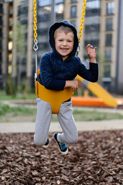 A little boy is having fun playing on the modern urban European playground — Stock Photo, Image