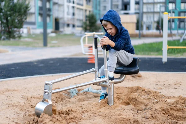 A little boy is having fun playing on the modern urban European playground — Stock Photo, Image