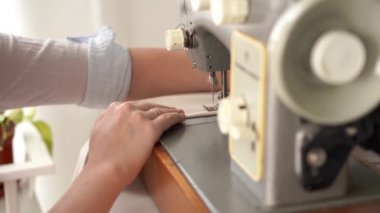 evde çalışmak. parlak bir odada bir daktilo genç sarışın kadın sews