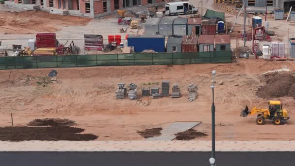 Construction d'un complexe résidentiel dans la ville, le tracteur nivelle le sol, timelapse . — Video