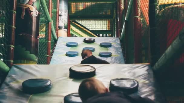 Two Little Boys Climb Hill Obstacles Entertainment Center — Stock Video