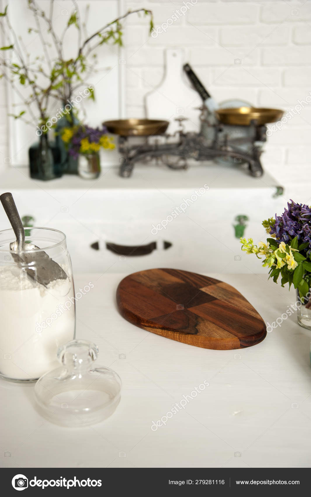 There Is A Chest By The White Brick Wall On It Are Vintage Scales