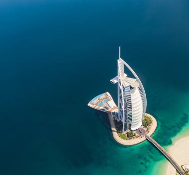 DUBAI, UAE - MARCH 2018: Aerial view of Burj Al Arab hotel in Dubai, one of the most luxury hotel in the world. clipart