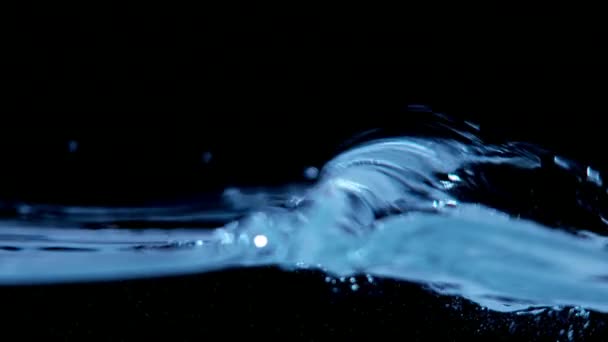 Super slow motion of water waves on black background — Stock Video