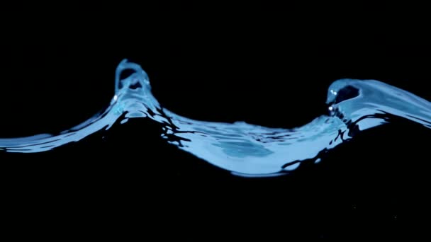 Super slow motion of water waves on black background — Stock Video