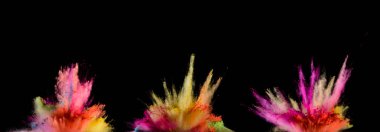 Explosions of coloured powder isolated on black background. Abstract colored background clipart