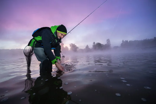 Fisherman Giving Freedom Predatory Small Fish Beautiful Sunrise Ligh Outdoor — Stock Photo, Image