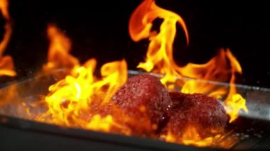 Süper ağır çekim alevler içine düşen sığır eti biftek. Yüksek hız sinema Kamerası, 1000 fps üzerinde filme.