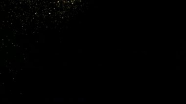 Süper ağır çekim altın ışıltılı, parçacıklar siyah arka plan üzerine, odak derinliği sığ. Yüksek hız sinema Kamerası, 1000 fps üzerinde filme.