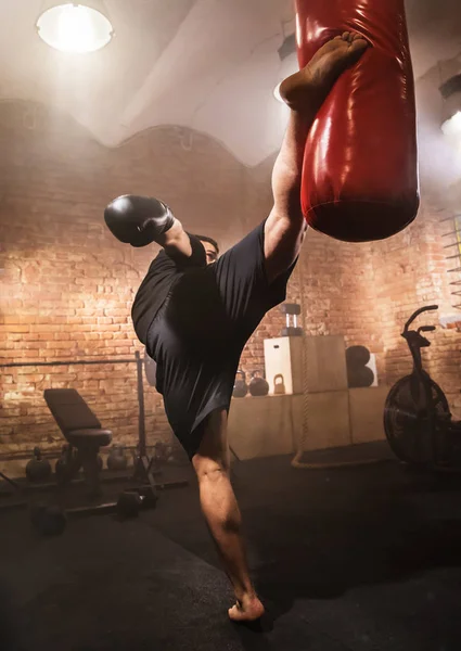 Young Man Hitting Punching Bag Training Lesson Dark Industrial Fitness — Stock Photo, Image