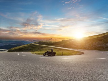 Motorcycle driver riding in Alpine road, Austria, Europe. Outdoor photography, mountain landscape. Travel and sport photography. Speed and freedom concept clipart