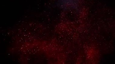Siyah arka plan üzerine süper ışıltılı, yavaş kırmızı parçacıklar. Odak sığ derinliği. Yüksek hız sinema Kamerası, 1000 fps üzerinde filme.