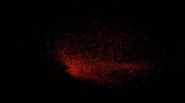 Siyah arka plan üzerine süper ışıltılı, yavaş kırmızı parçacıklar. Odak sığ derinliği. Yüksek hız sinema Kamerası, 1000 fps üzerinde filme.