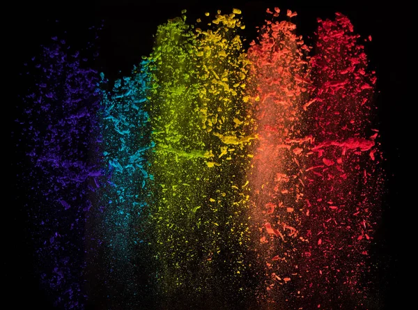 Abstract falling colored powder isolated on black — Stock Photo, Image