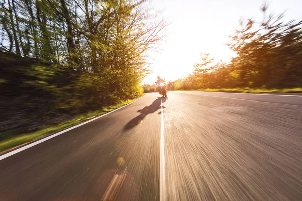 Motorcycle driver riding in European road — Stock Photo, Image