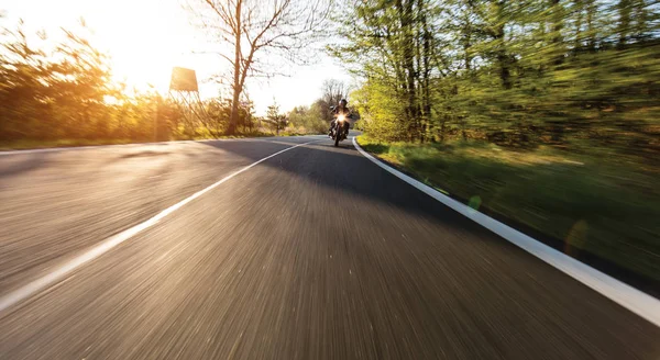 Motorcycle driver riding in European road — Stock Photo, Image