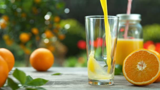 Super Slow Motion Pouring Orange Juice Glass Filmed High Speed — Stock Video