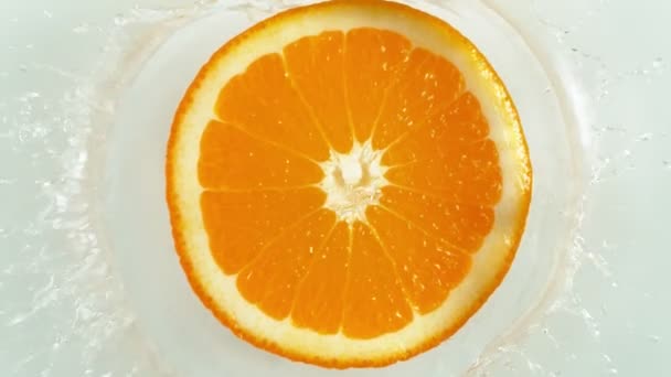 Super Slow Motion Falling Orange Splashing Water Filmed High Speed — Stock Video