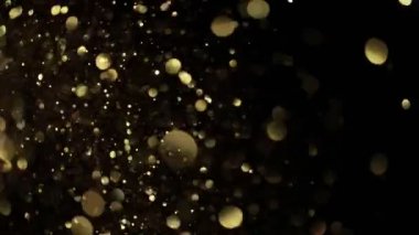 Siyah zemin üzerinde ışıldayan altın parçacıkların süper yavaş çekimi. Sığ odak derinliği. Yüksek hızlı sinema kamerası, 1000 fps..
