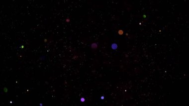 Siyah arka plan üzerinde parlak renkli parçacıkların süper yavaş hareket, düşük dof. Yüksek hızlı sinema kamera, 1000 fps filme.