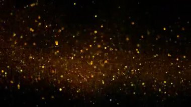 Siyah zemin üzerinde ışıldayan altın parçacıkların süper yavaş çekimi. Sığ odak derinliği. Yüksek hızlı sinema kamerası, 1000 fps..