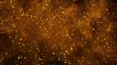 Siyah zemin üzerinde ışıldayan altın parçacıkların süper yavaş çekimi. Sığ odak derinliği. Yüksek hızlı sinema kamerası, 1000 fps..