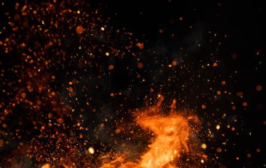 Detail of fire sparks isolated on black background clipart