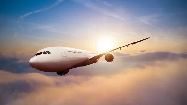 Passengers commercial airplane flying above clouds Stock Image