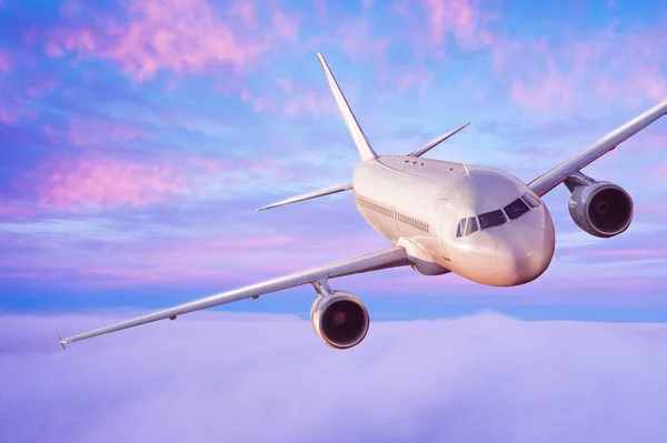 Passengers commercial airplane flying above clouds — Stock Photo, Image