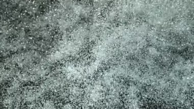 Siyah arka planda izole edilmiş süper yavaş beyaz toz patlaması. Yüksek hızlı sinema kamerası, 1000fps.