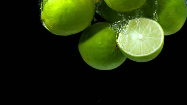 Super Slow Motion Falling Lime Pieces Splashing Water Filmed High — Stock Video