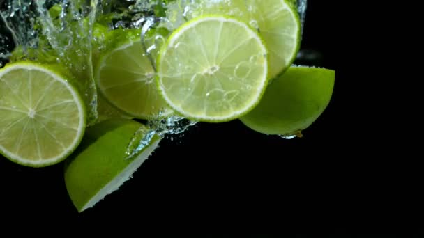 Super Slow Motion Falling Lime Pieces Splashing Water Filmed High — Stock Video
