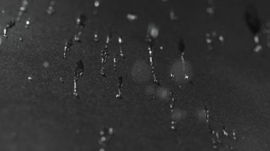 Ayrıntılı olarak su geçirmez bez doku üzerine düşen su damlaları Süper yavaş hareket. Yüksek hızlı sinema kamera, 1000 fps filme.