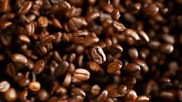 Coffee beans flying in the air, macro photo — Stock Photo, Image