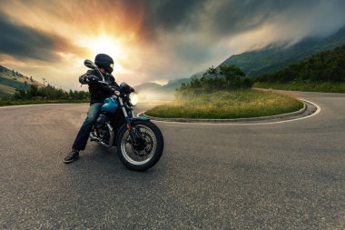 Alp manzara poz motosiklet sürücüsü.