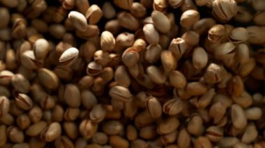 Siyah arka plan üzerinde uçan antep fıstığı Süper yavaş hareket. Yüksek hızlı sinema kamera, 1000 fps filme.