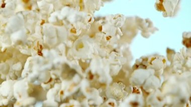 Renkli arka plan üzerine düşen patlamış mısır Süper yavaş hareket. Yüksek hızlı sinema kamera, 1000fps filme.