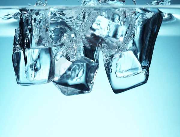 Gruppe von Eiswürfeln fällt ins Wasser — Stockfoto
