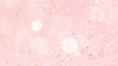 Parlak pembe parçacıkların süper yavaş hareketi. Sığ odak derinliği. Yüksek hızlı sinema kamera, 1000 fps filme.