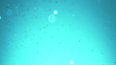 Parlak mavi parçacıkların süper yavaş hareketi. Sığ odak derinliği. Yüksek hızlı sinema kamera, 1000 fps filme.