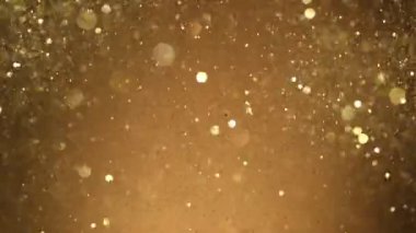 Siyah zemin üzerinde ışıldayan altın parçacıkların süper yavaş çekimi. Sığ odak derinliği. Yüksek hızlı sinema kamerası, 1000 fps..
