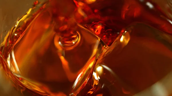 Super macro shot of pouring spirit into glass — Stock Photo, Image