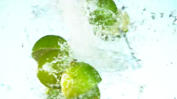 Super Slow Motion Lime Pieces Collision Water Splashes White Background — Stock Video