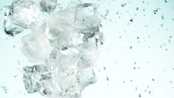 Super Slow Motion Ice Cubes Collision Blue Background Filmed High — Stock Video