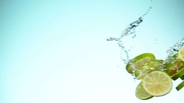 Super Slow Motion Lime Pieces Collision Water Splashes White Background — Stock Video