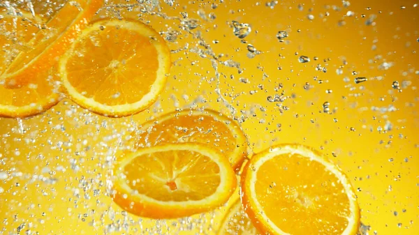 Bevriezen Beweging Van Vliegende Oranje Stukken Met Water Spatten Studio — Stockfoto