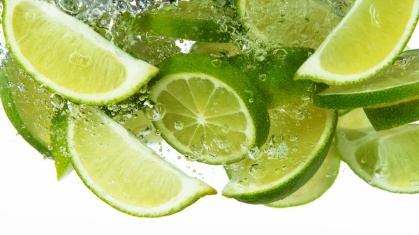 Lime Slices Falling Deeply Water Isolated White Background — 图库照片