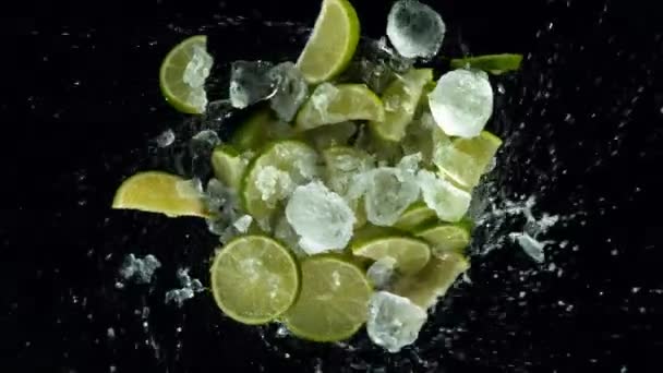 Super Slow Motion Lime Slices Ice Rotating Water Black Background — Stock Video