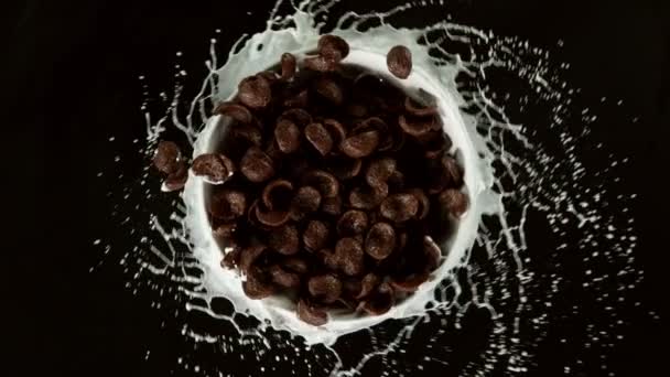 Super Slow Motion Rotating Cereal Chocolate Pieces Milk Splashes Filmed — Stock Video